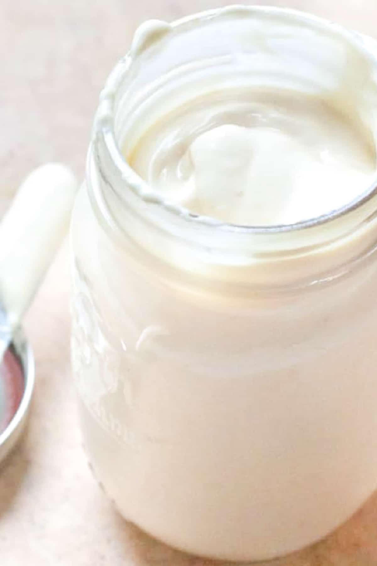 an open mason jar of mayo.