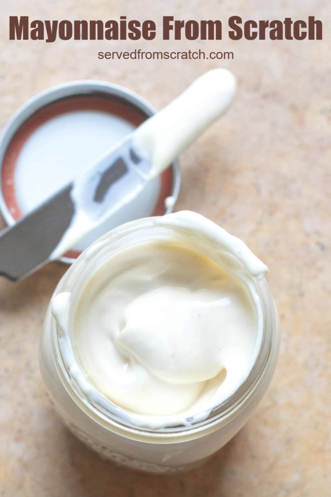 an overhead of an open mason jar of creamy mayonnaise and knife on counter with Pinterest pin text.