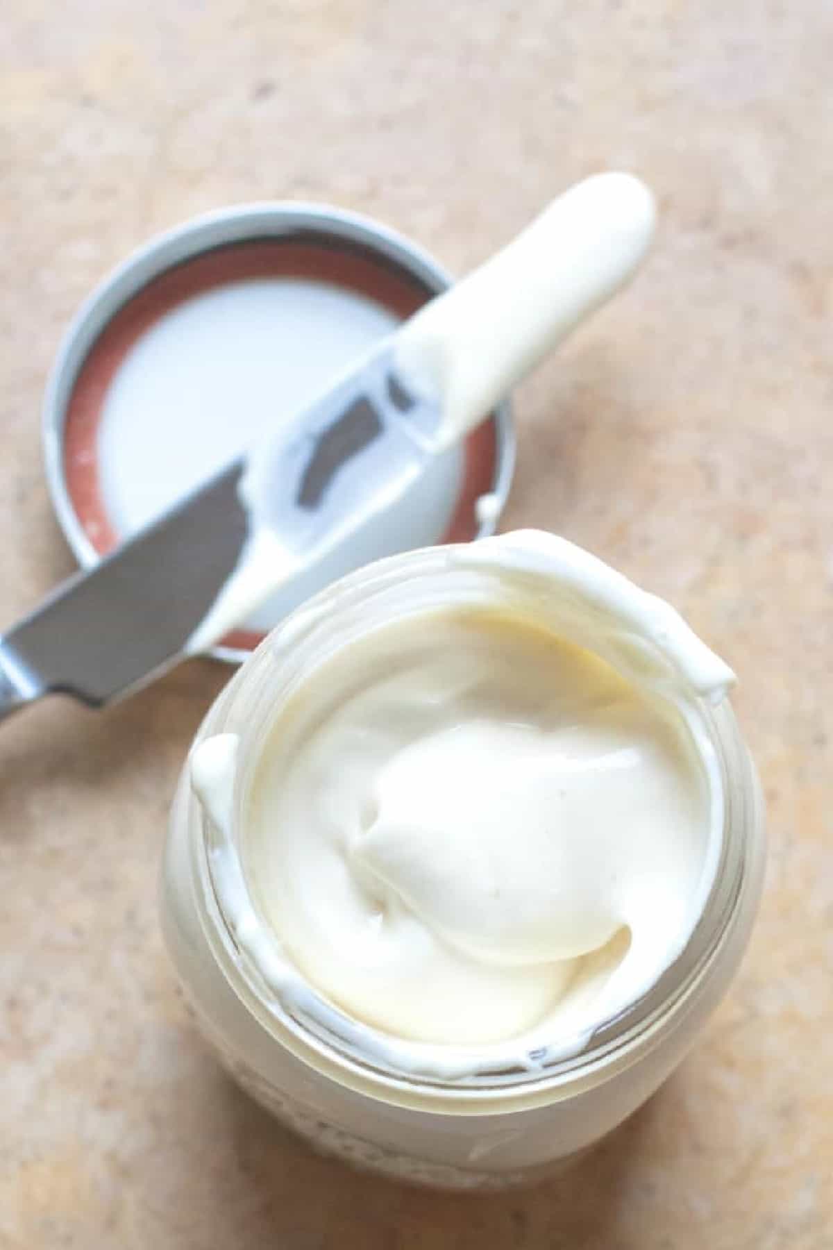 an overhead of a jar of creamy mayo.