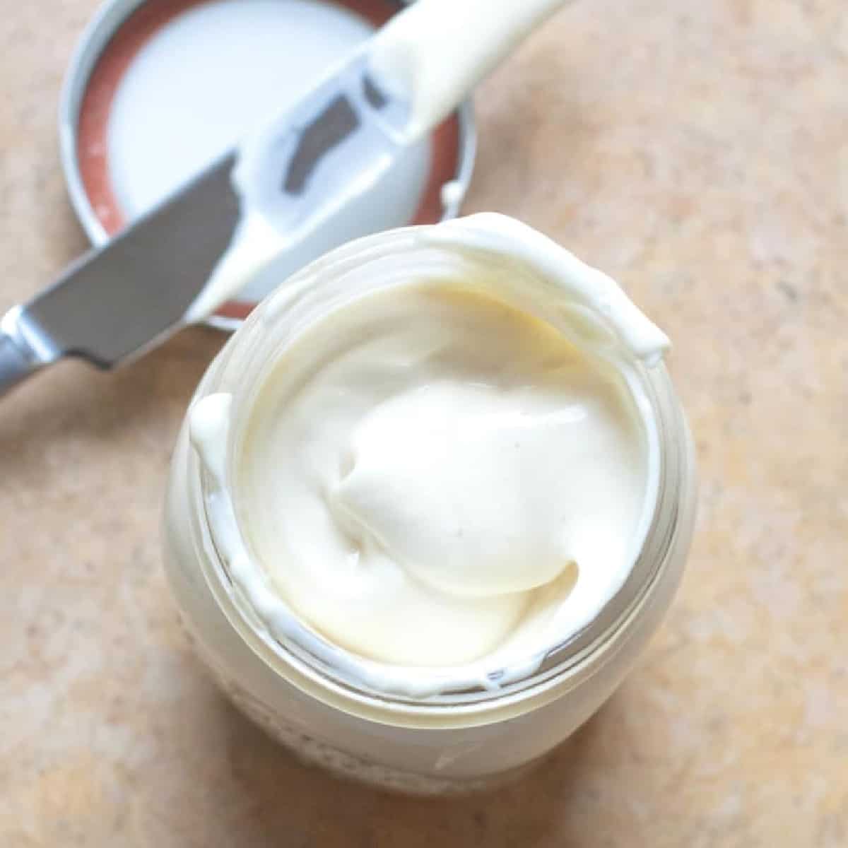 an overhead of a jar of creamy mayo.