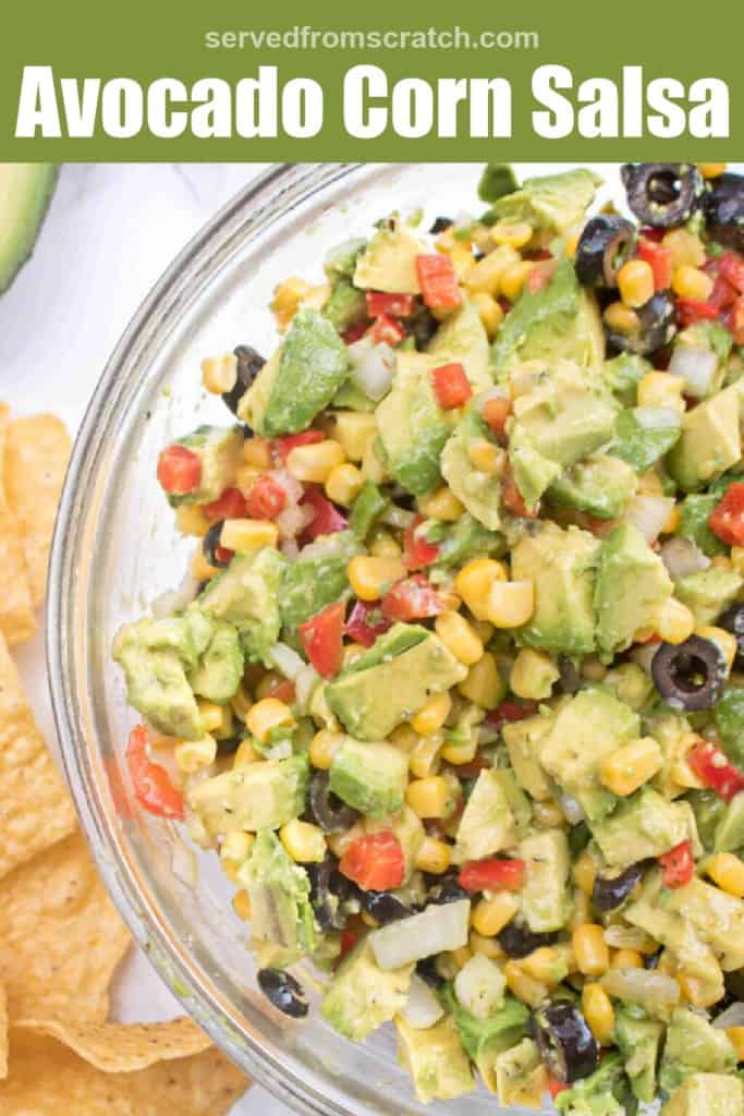 a bowl of corn, avocado, peppers, olives and Pinterest pin text.