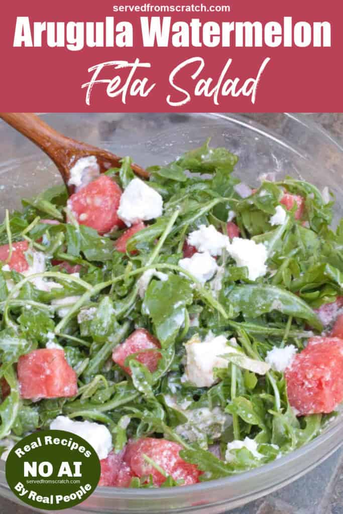 a bowl with a salad of arugula, feta, and watermelon with Pinterest pin text and NO AI sticker.