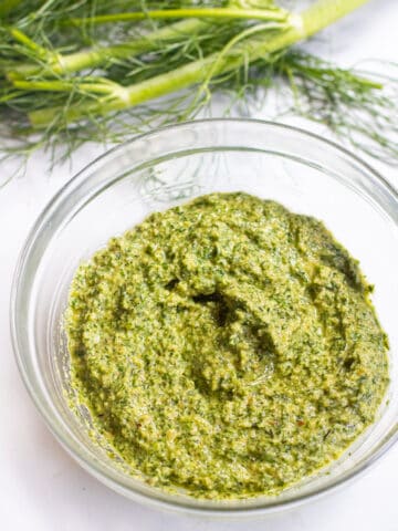 a bowl of pesto and fennel fronds.