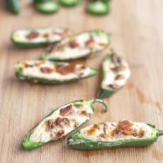 jalapenos halved and stuffed with cream cheese and crumbled bacon