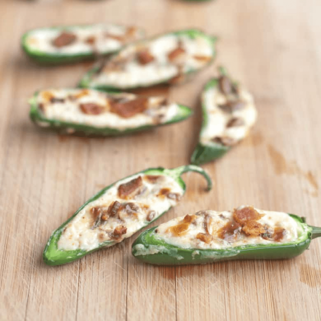 jalapenos halved and stuffed with cream cheese and crumbled bacon