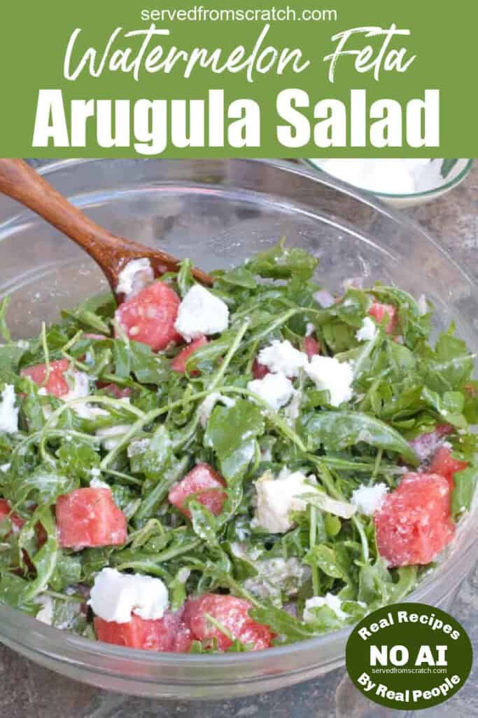 a bowl with a salad of arugula, feta, and watermelon with Pinterest pin text and NO AI sticker.