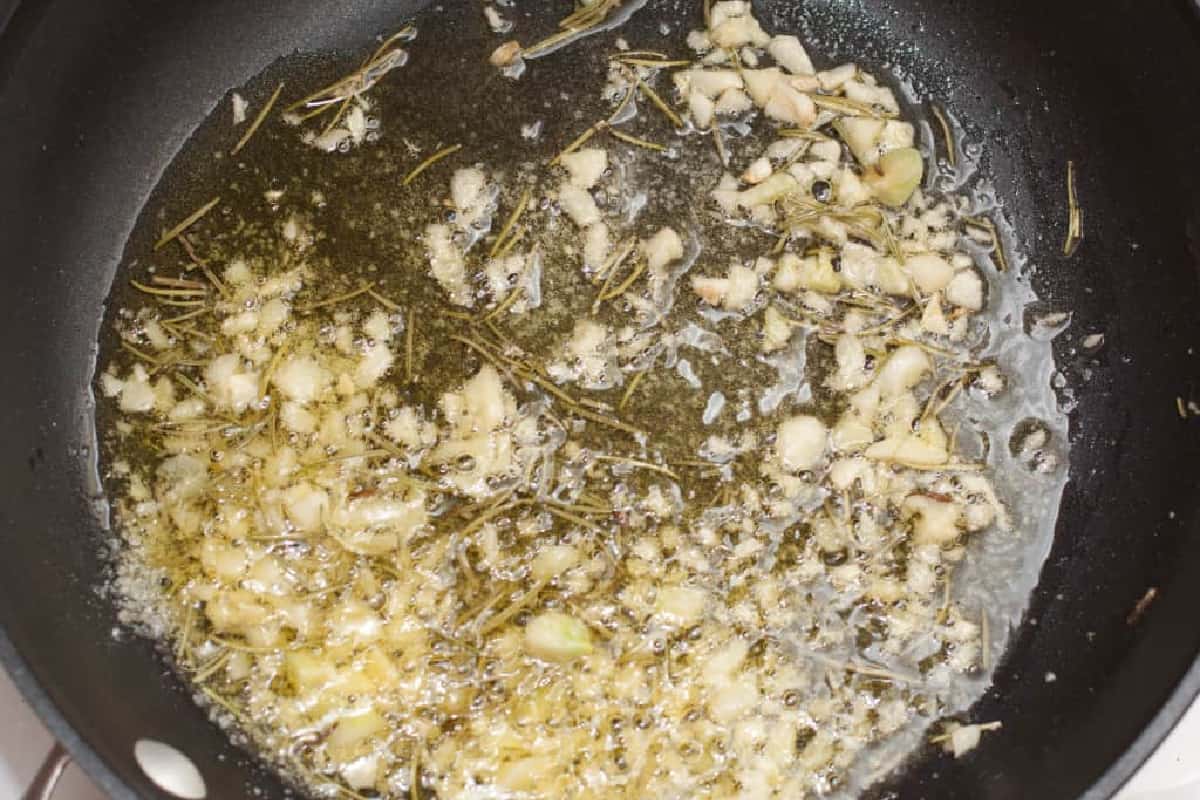 garlic and oil cooking in a pan.