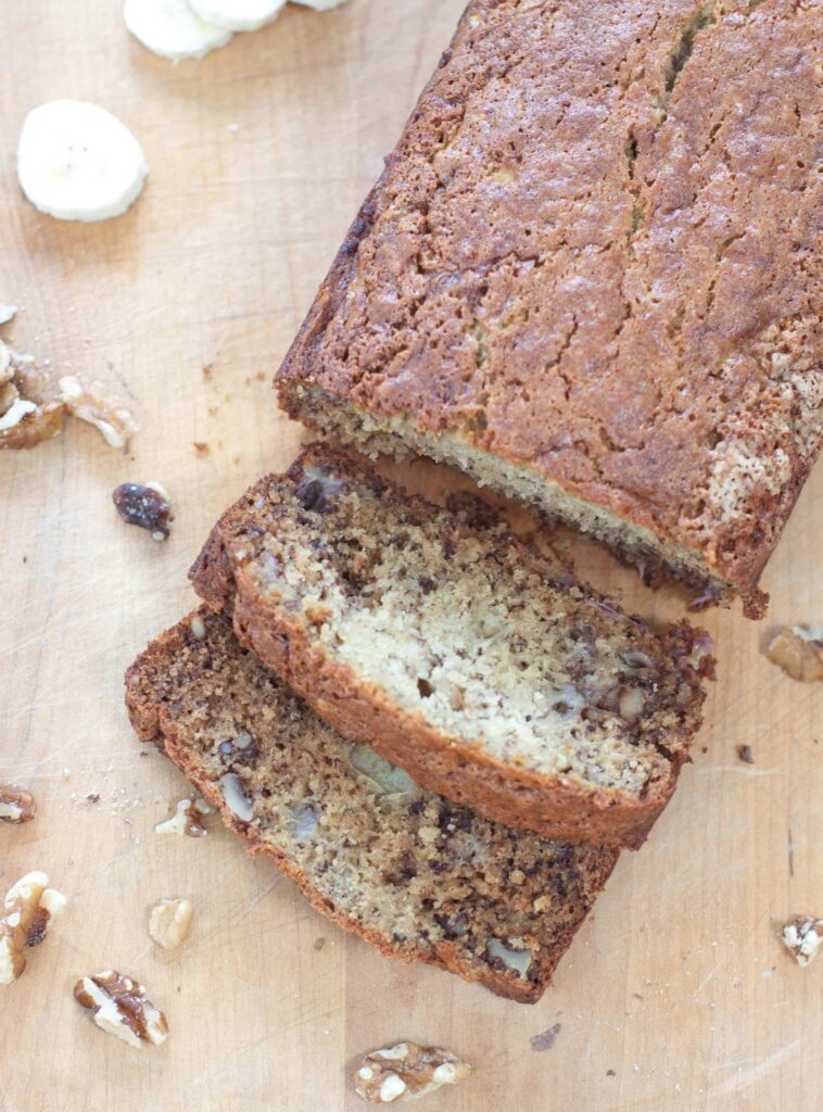 an overhead of a loaf of banana bread sliced 