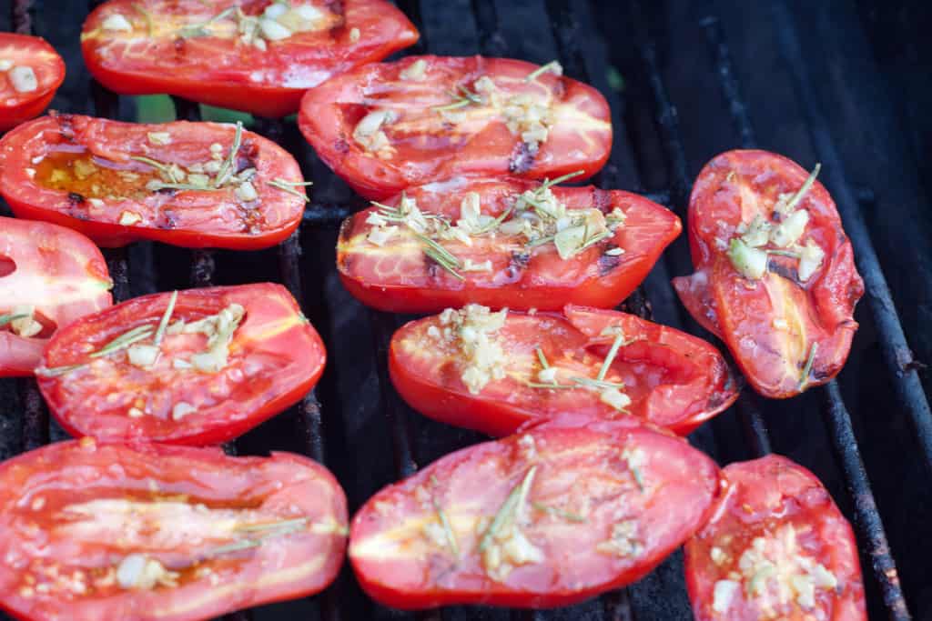 halved tomatoes grilled topped with oil and herbs.