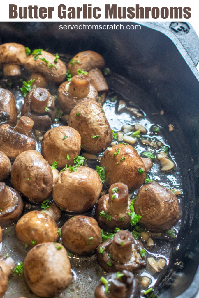 a cast iron with cooked mushrooms in butter and garlc.