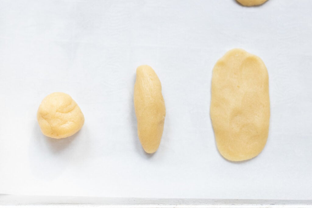 3 pieces of dough, one in a ball, one in a log, and one flattened.