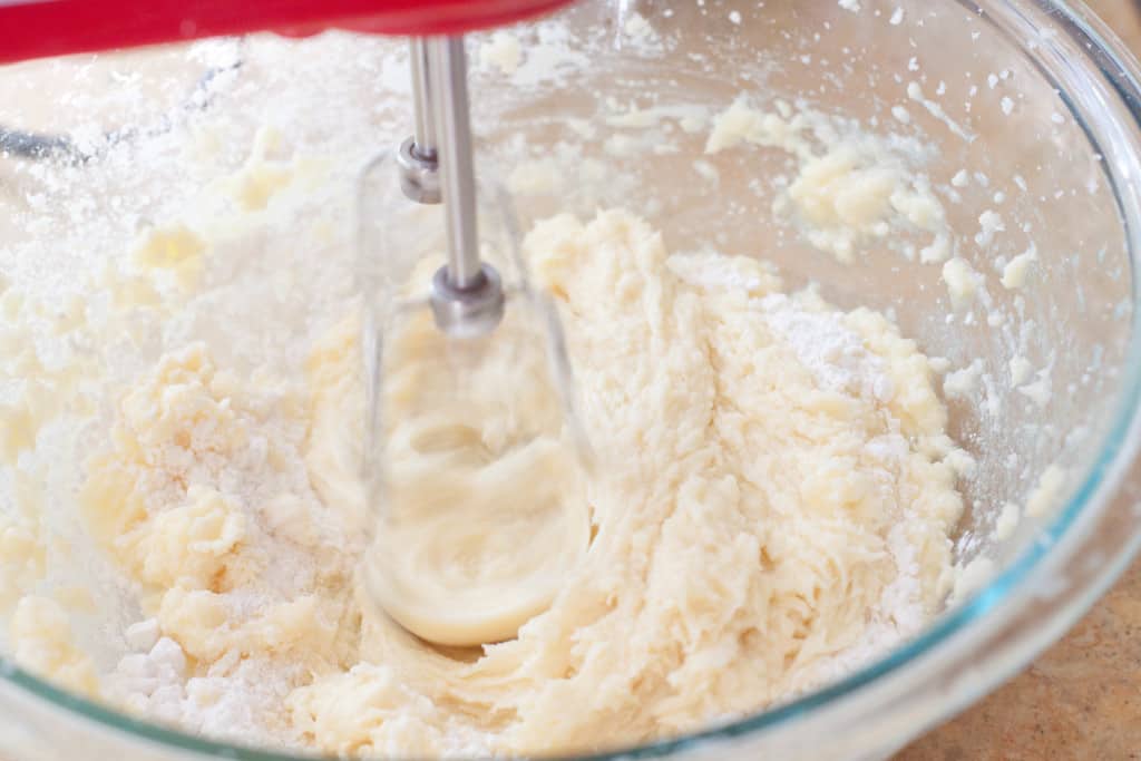 hand beater mixing a dough in a bowl