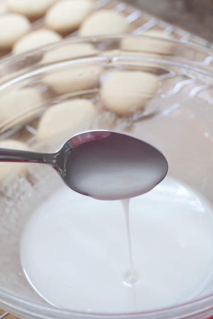a bowl of icing with a spoon