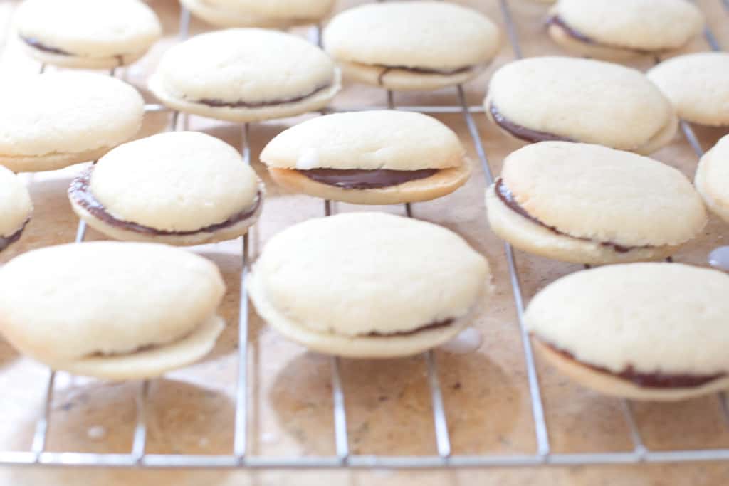 a cooling rack of sandwich cookies