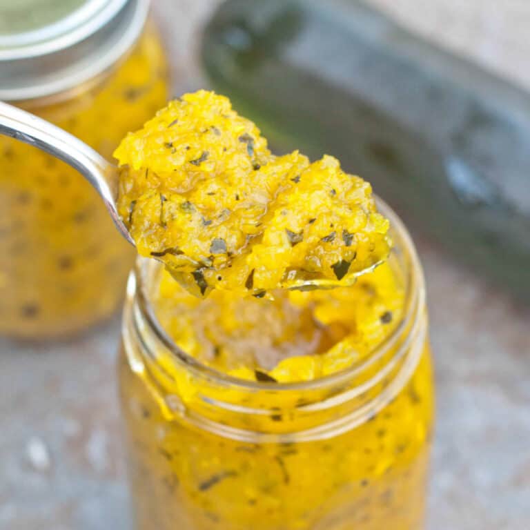 an open jar of relish with a forkful out of it.