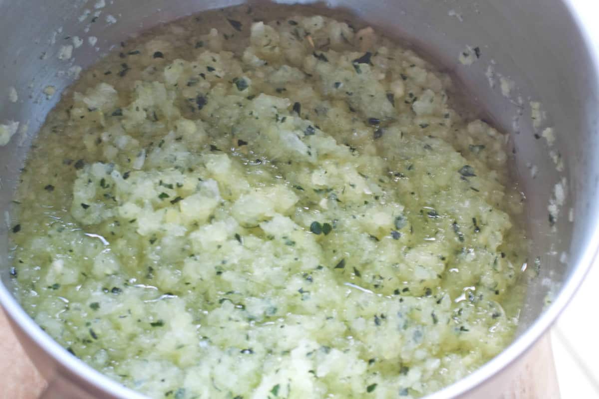 a pot with ground zucchini and onion.
