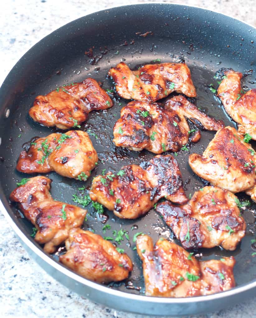 cooked boneless chicken thighs in a pan glazed in soy and maple.