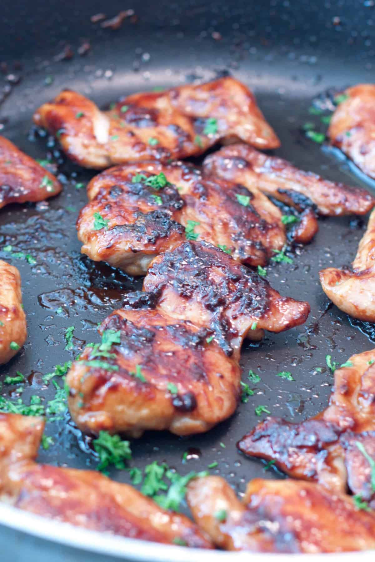 a pan of glazed cooked chicken thighs.
