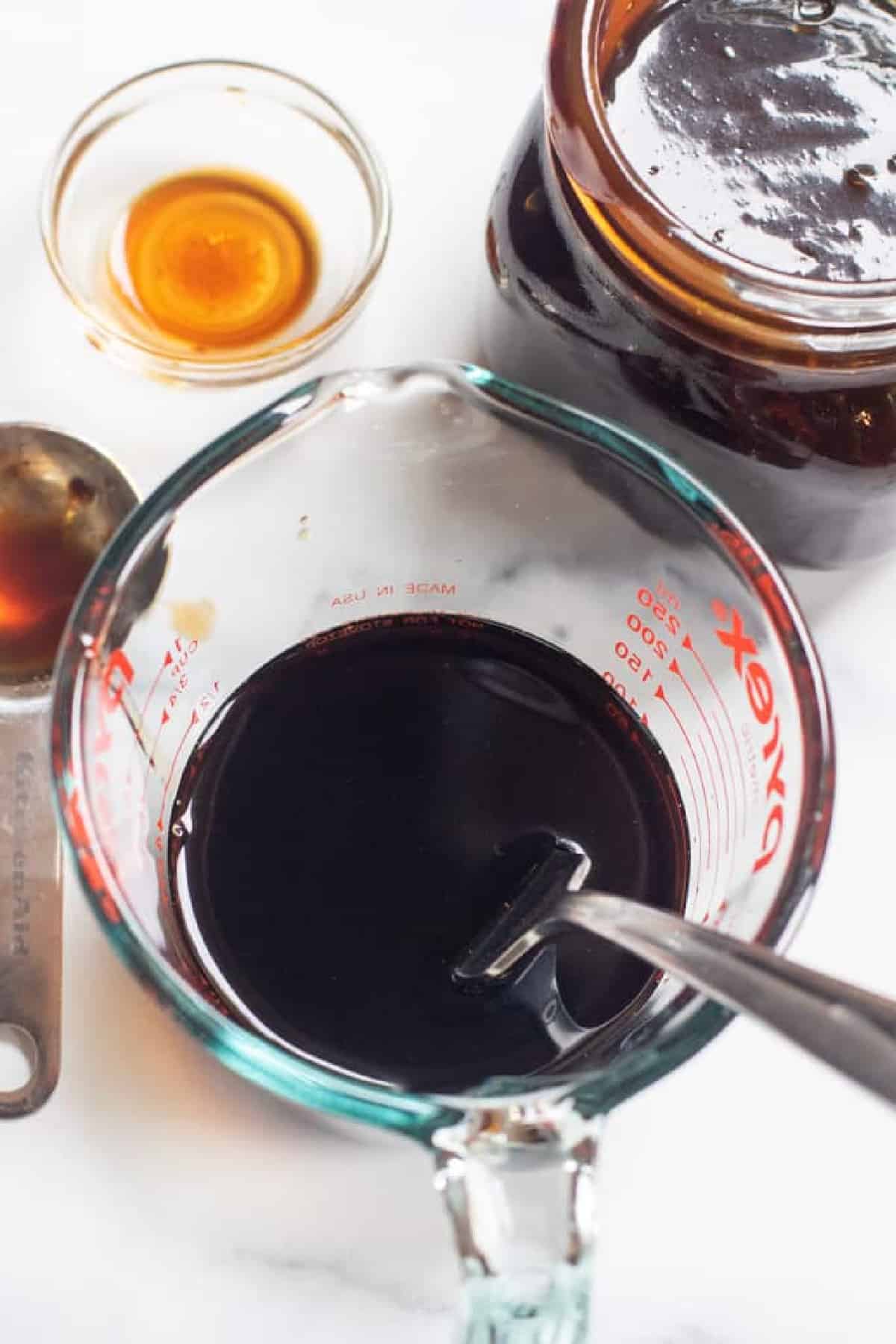 a Pyrex with dark sauce in it and a fork.