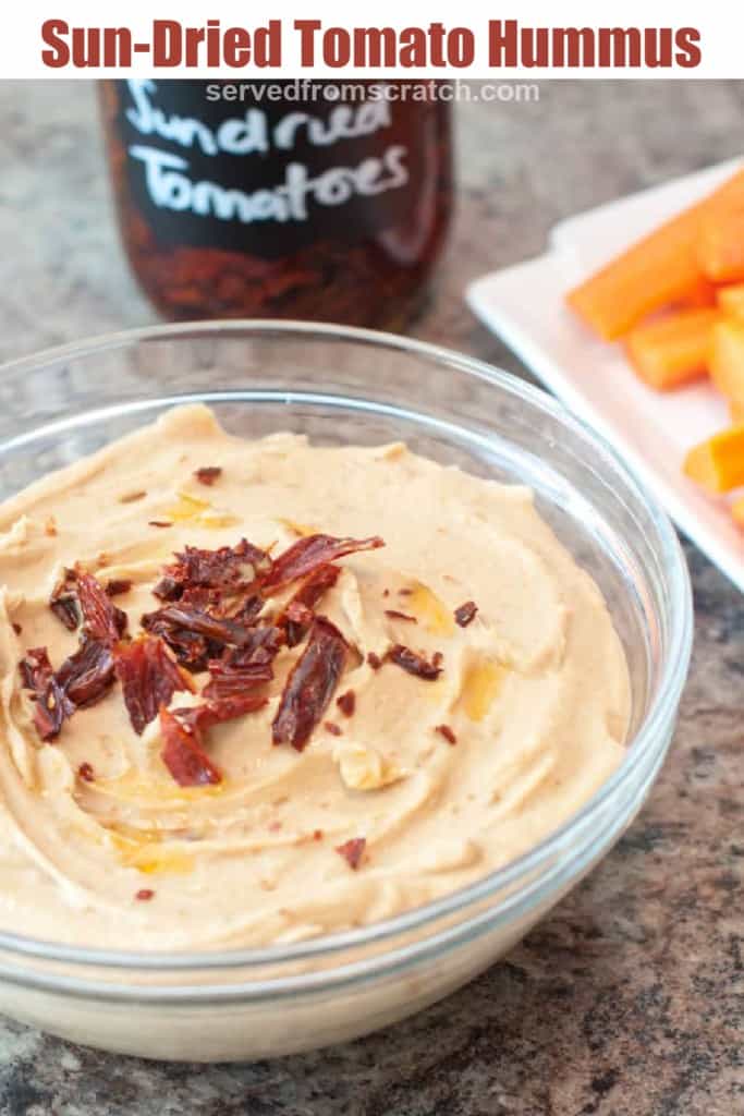 a bowl of hummus with sun-dried tomatoes with Pinterest pin text.