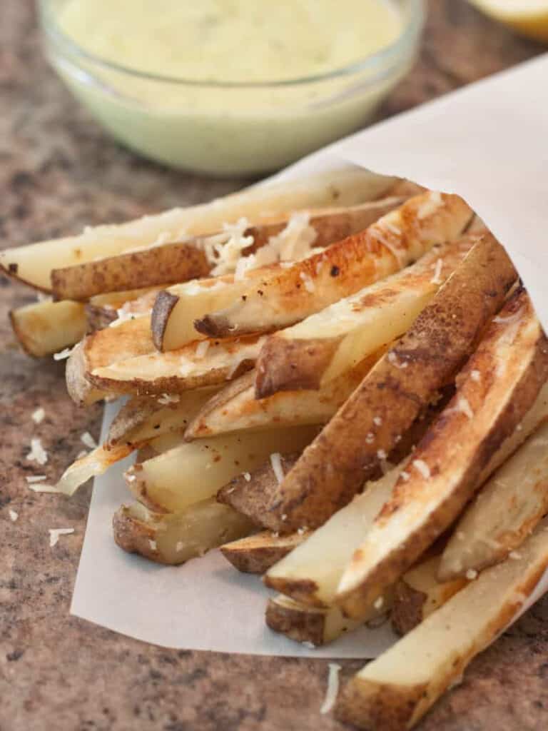 steak fries with aioli in the background.