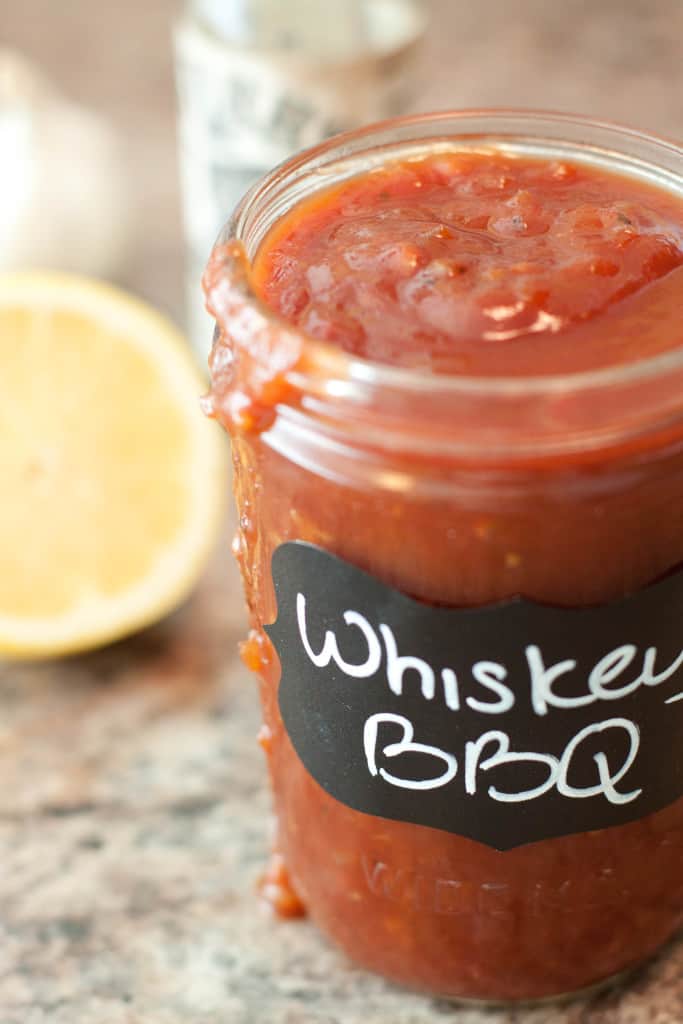 a close up of an open jar of whiskey bbq sauce.