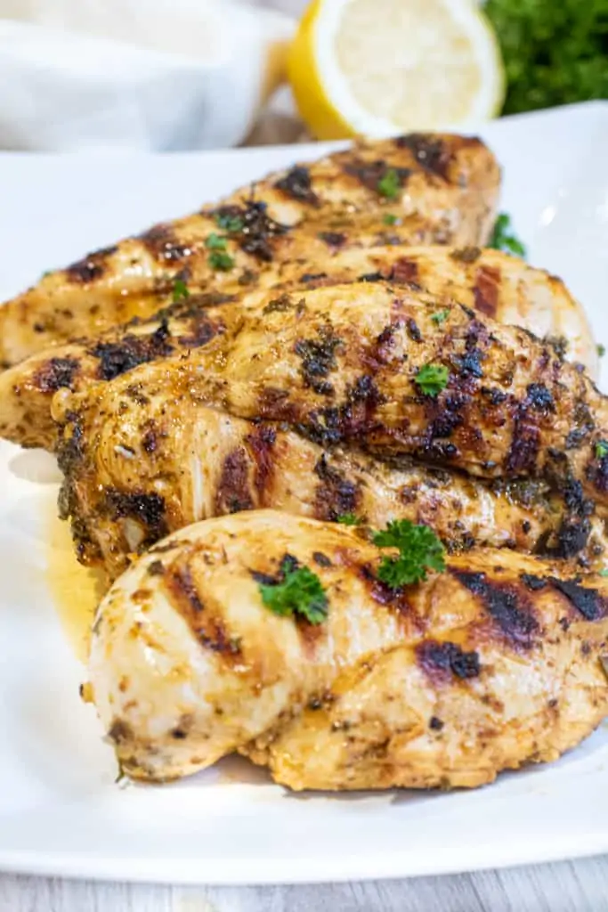 a plate of grilled chicken breasts.