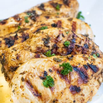 a plate of grilled chicken breasts.