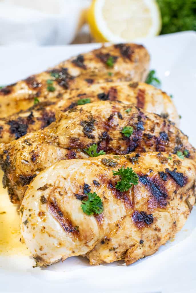 a plate of grilled chicken breasts.