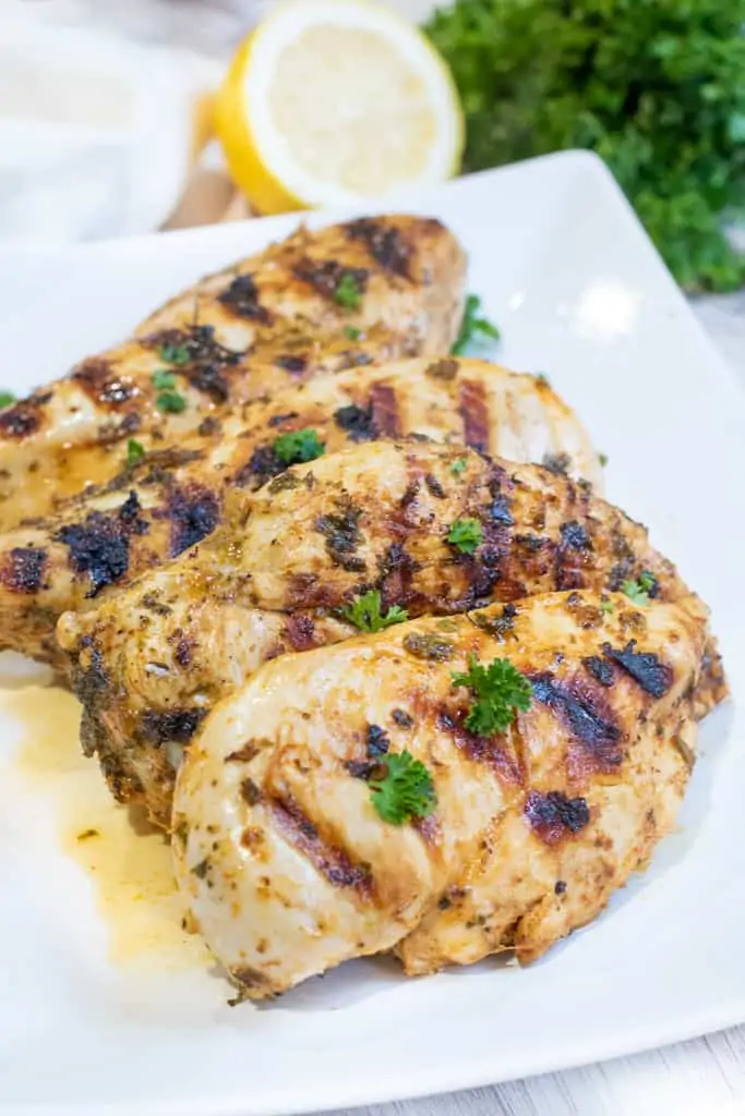 a plate of grilled chicken breasts.