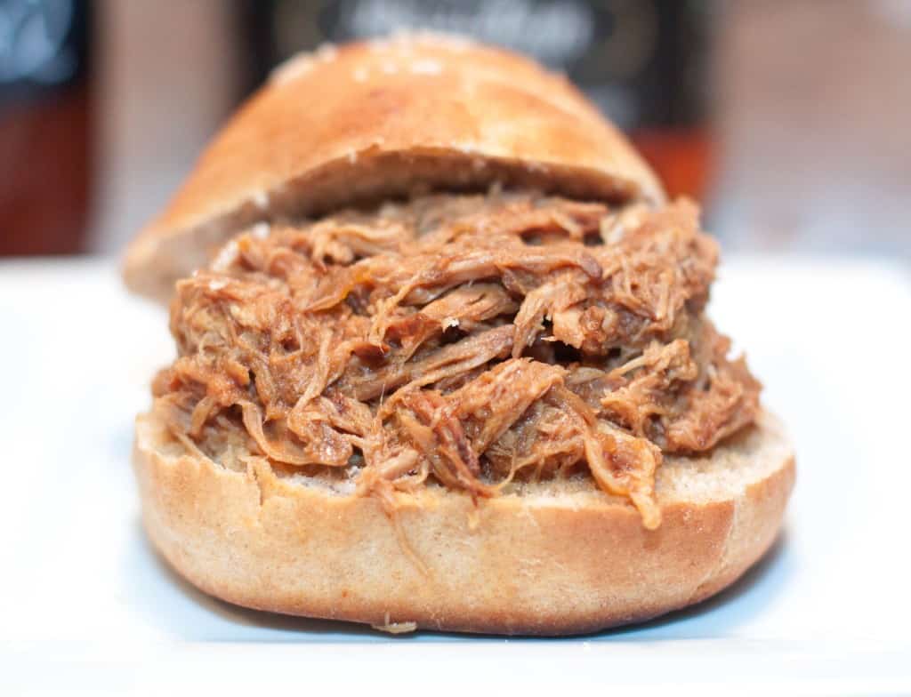 overly stuffed pulled pork sandwich on a hamburger bun