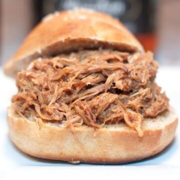 overly stuffed pulled pork sandwich on a hamburger bun