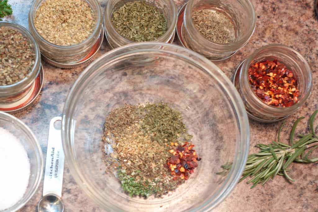 a small bowl surrounded by spice jars.