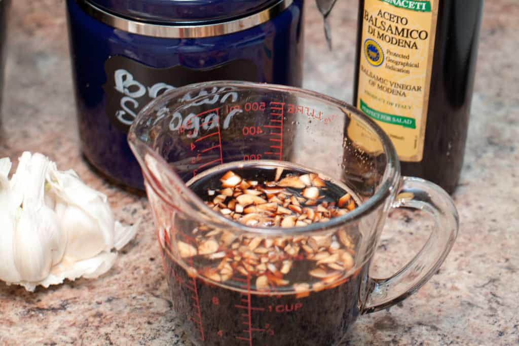 measuring cup with balsamic and garlic.