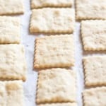 baked saltine crackers on parchment paper.