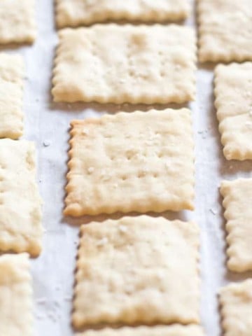 baked saltine crackers on parchment paper.