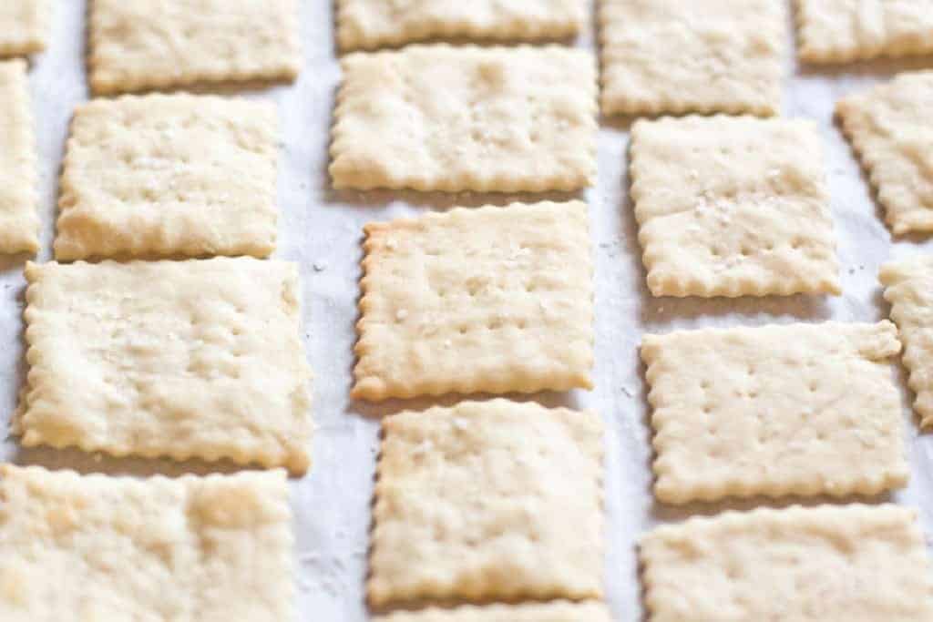 baked saltine crackers on parchment paper.