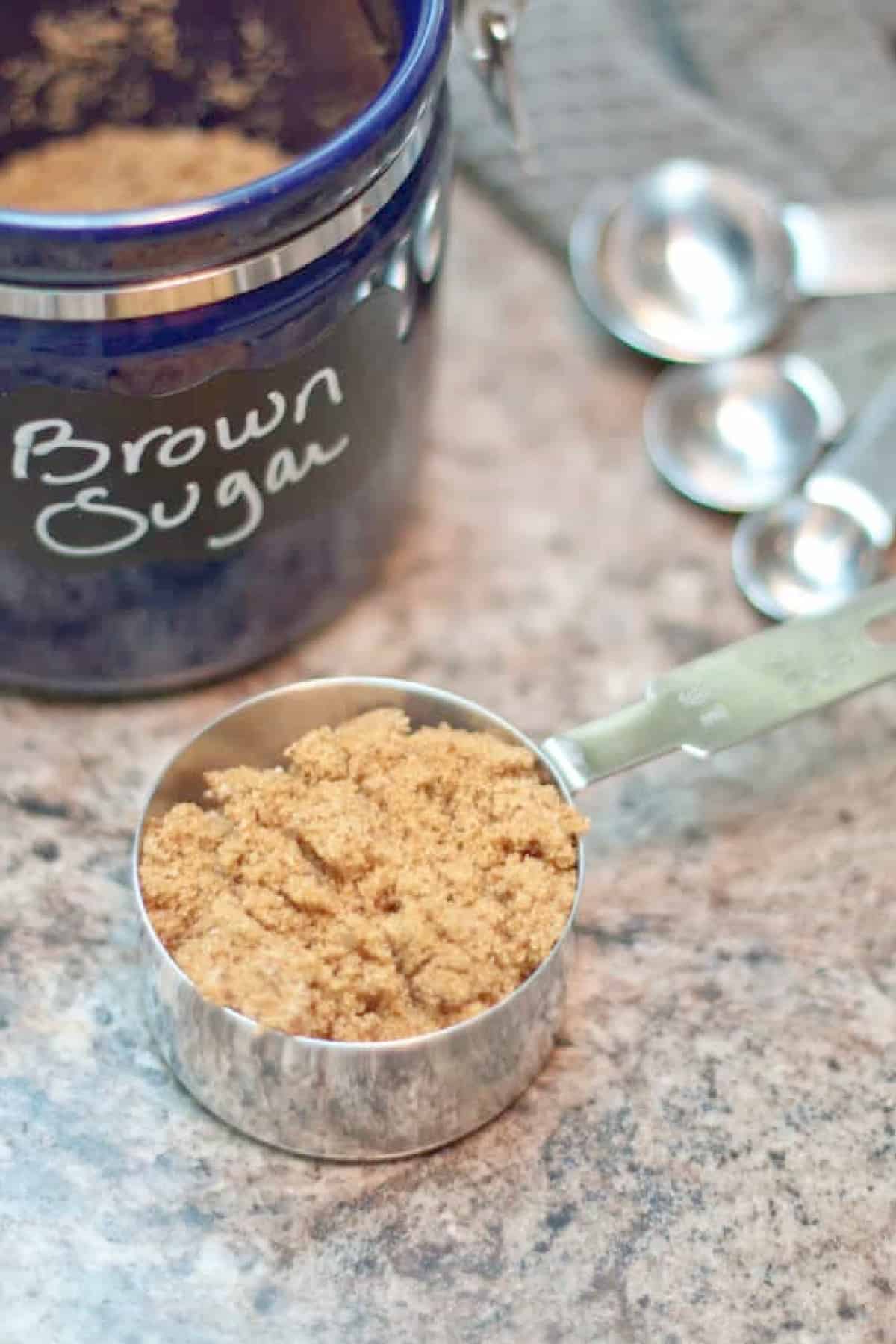 a measuring cup with brown sugar.