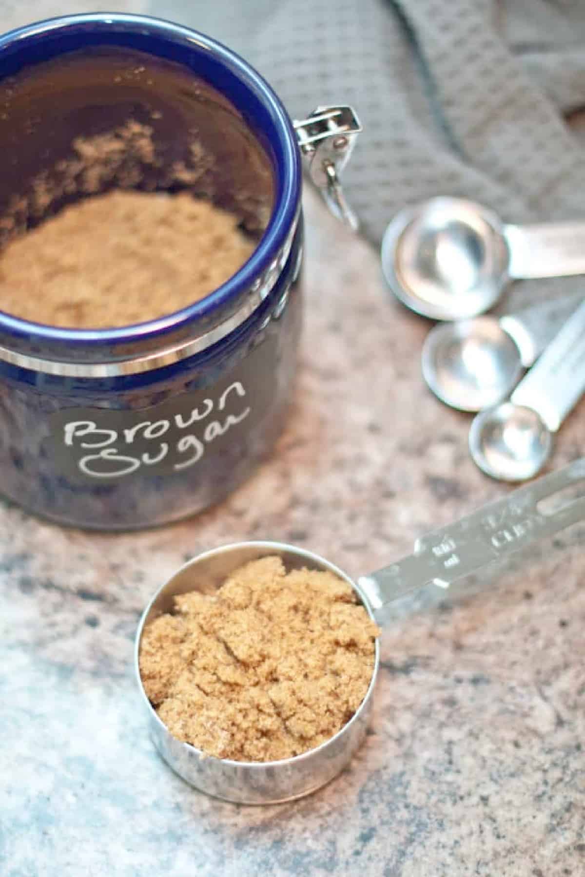 a measuring cup with brown sugar.