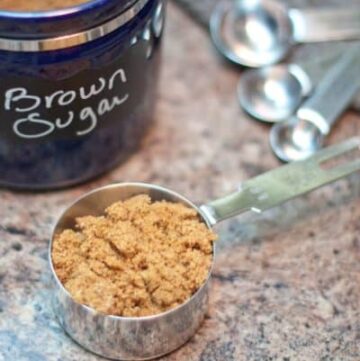 a measuring cup with brown sugar