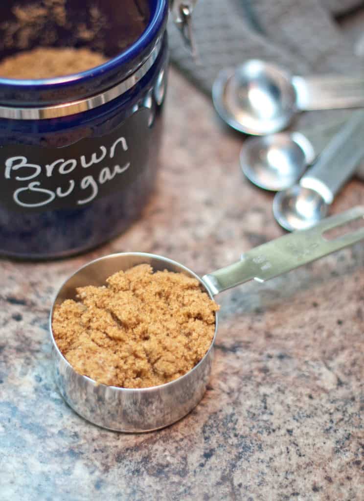 a measuring cup with brown sugar