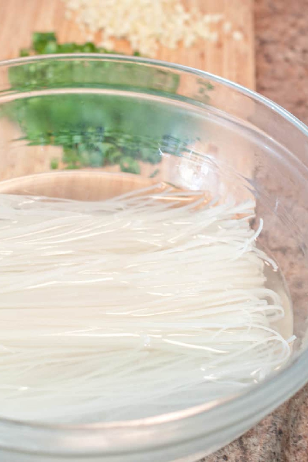rice noodles soaking in a bowl of water.