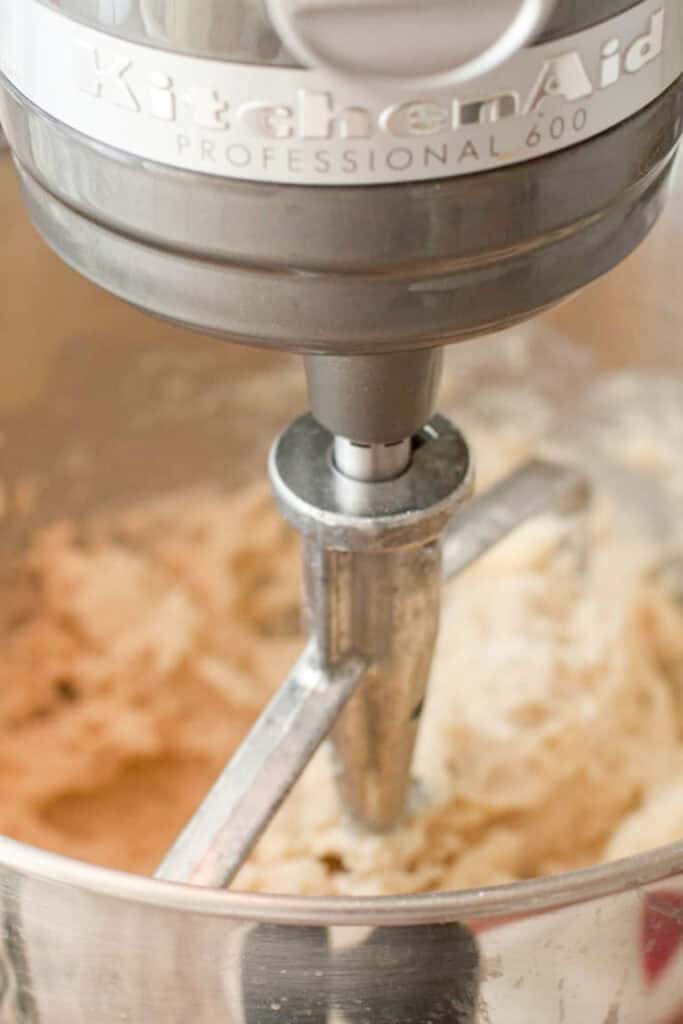 a stand mixer with dough in it.