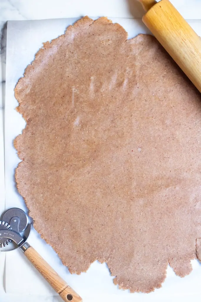 rolled out dough on parchment paper.