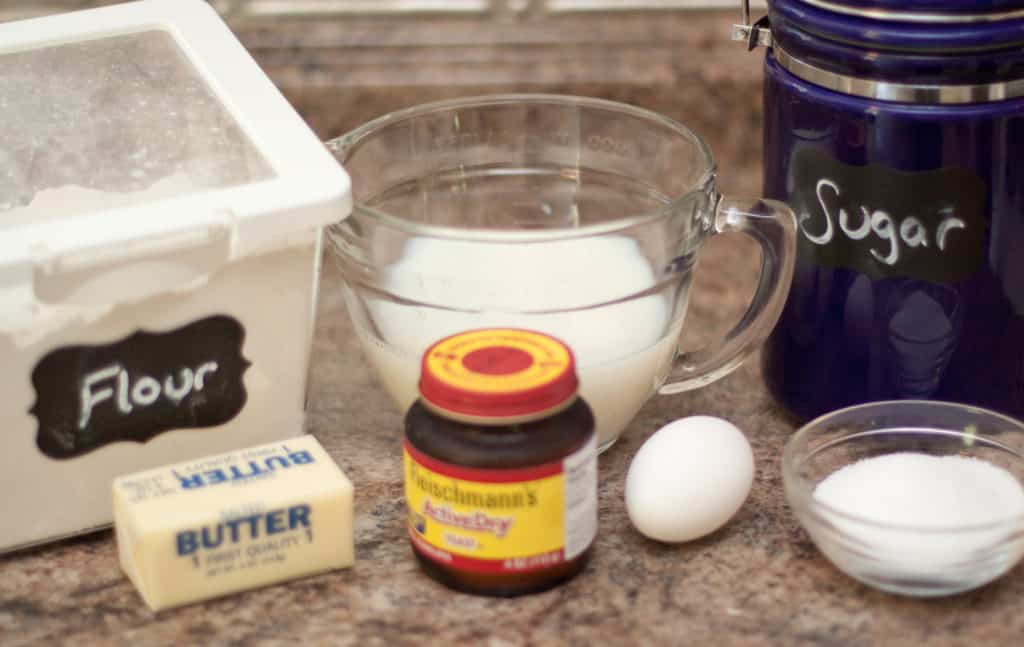 flour, butter, milk, yeast, egg, salt, and sugar on counter