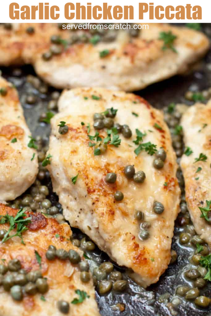 a close up of chicken in a pan topped with capers.