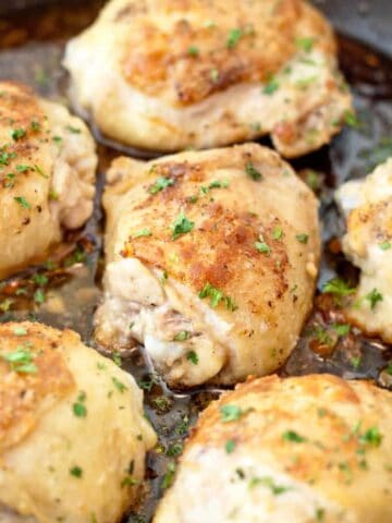 a pan with baked chicken thighs.