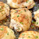 skin on baked chicken thighs in a pan.