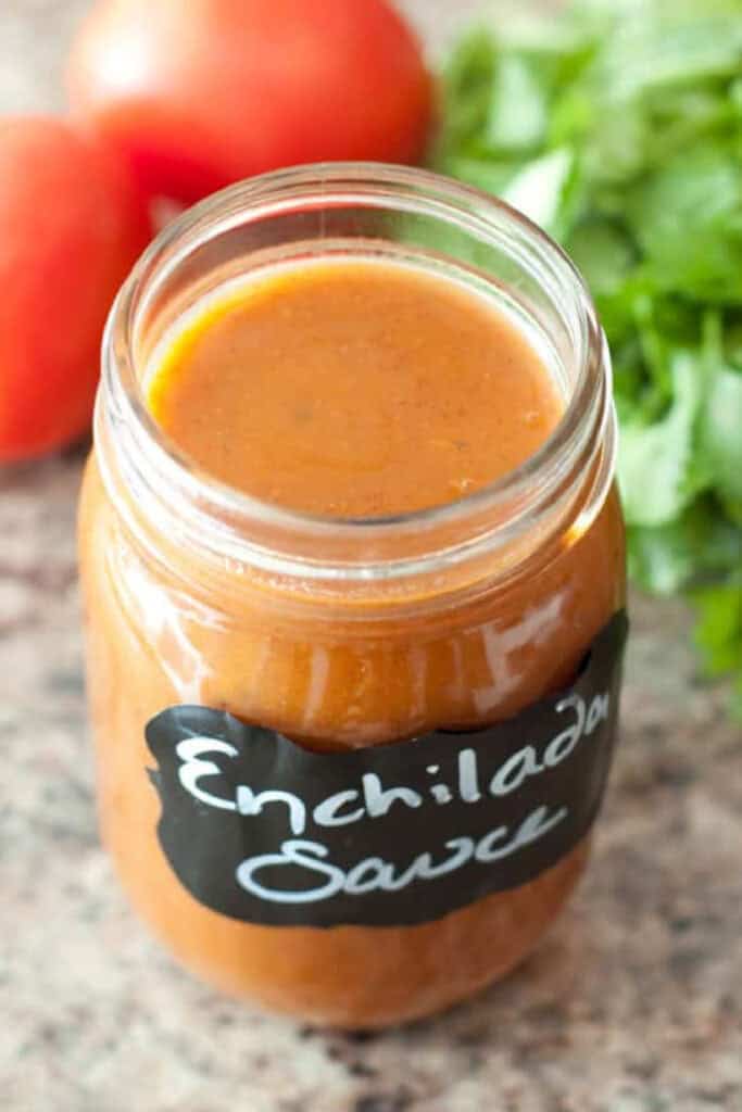an open labeled jar of enchilada sauce.
