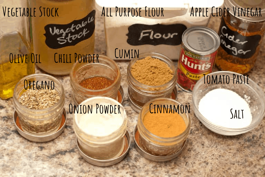 stock, oil, flour, cider vinegar, spices, salt, tomato paste on counter